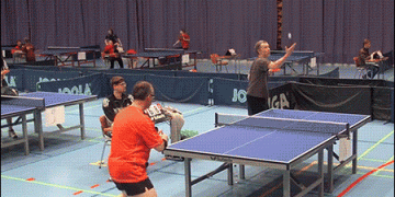 Two guys playing extreme ping pong.